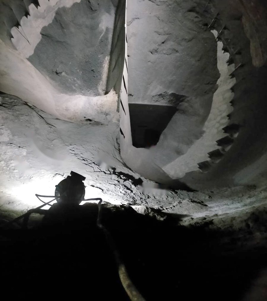 Coal bunker before cleaning — hardened build-up covering the bunker walls and restricting material flow